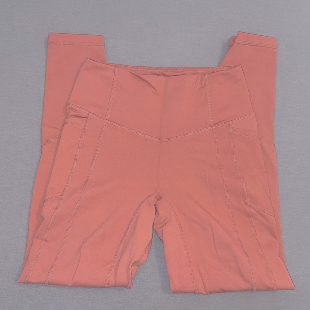 Pink athletic leggings with pockets.